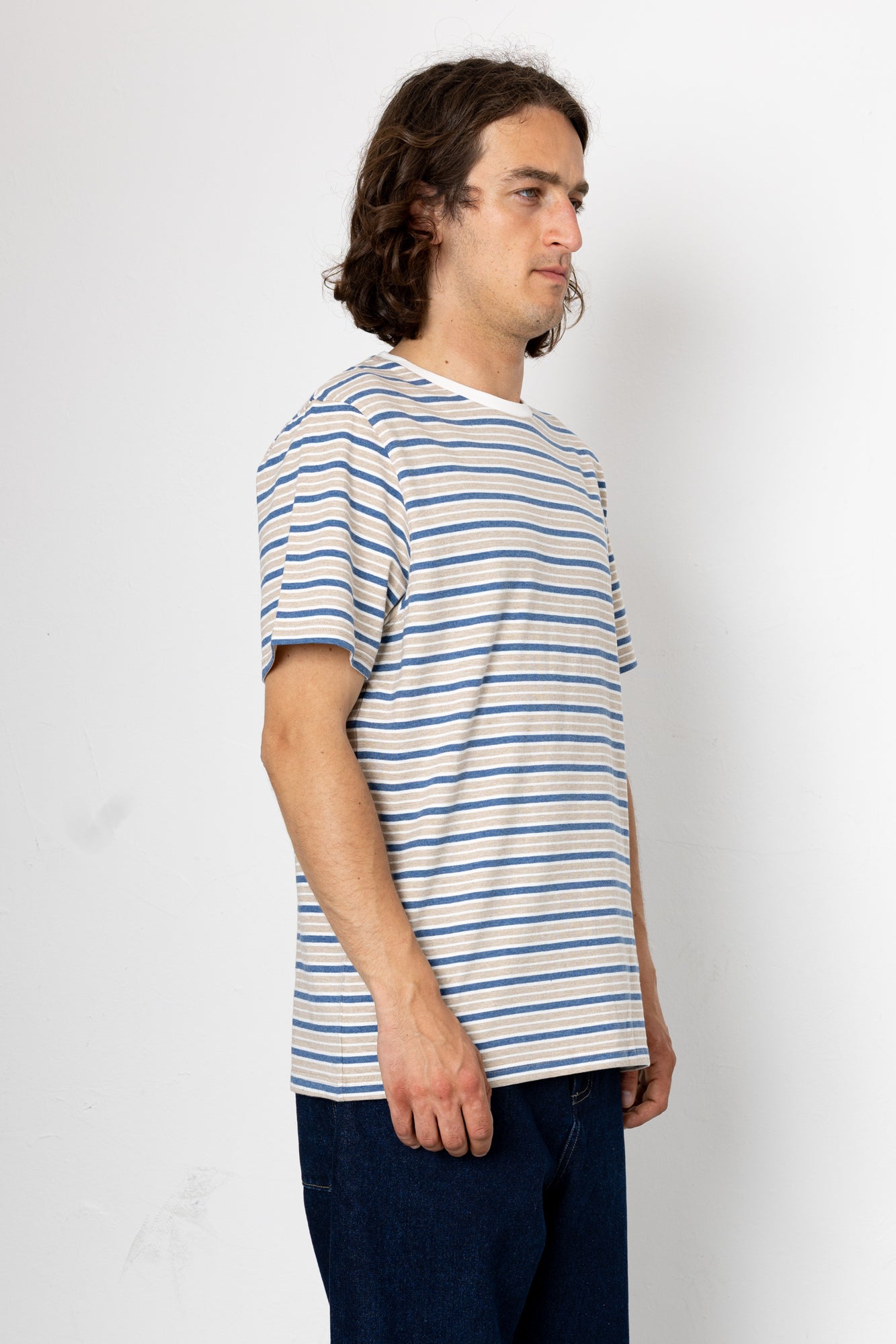 Man wearing a striped t-shirt against a white background