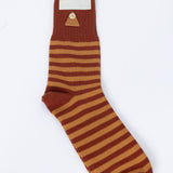 Brown and beige striped sock with 'Folk' label on a white background