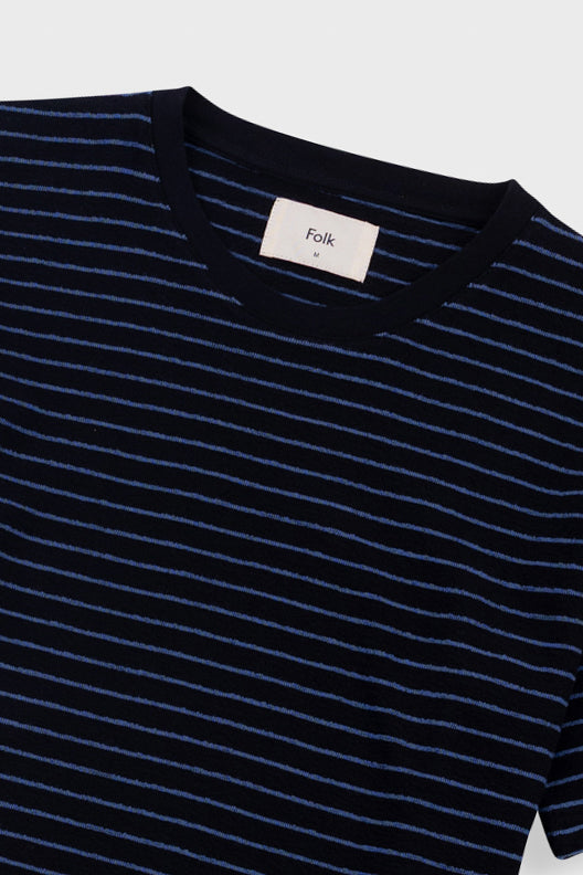 Black and white striped t-shirt on a light gray background