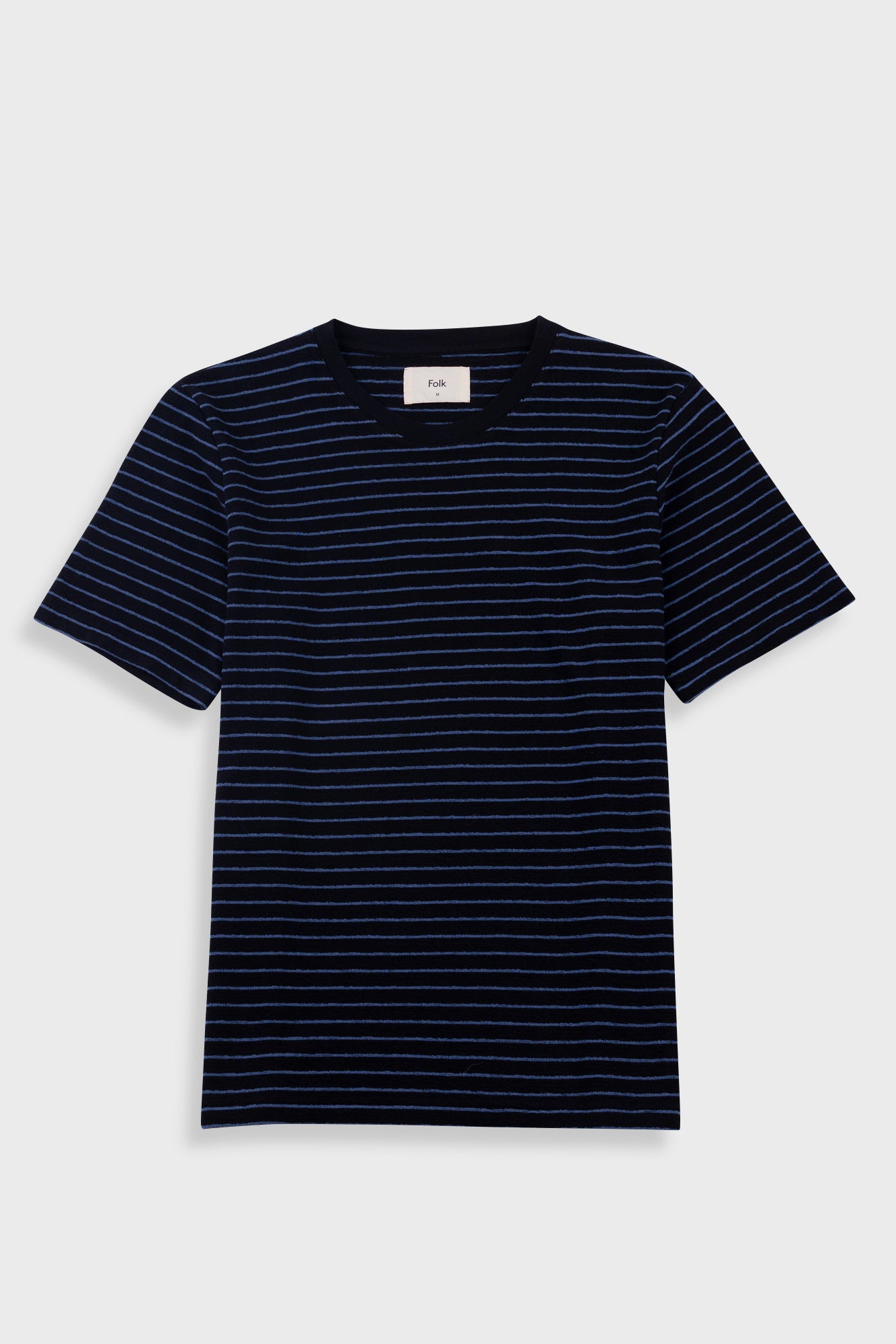 Black and white striped t-shirt on a light gray background
