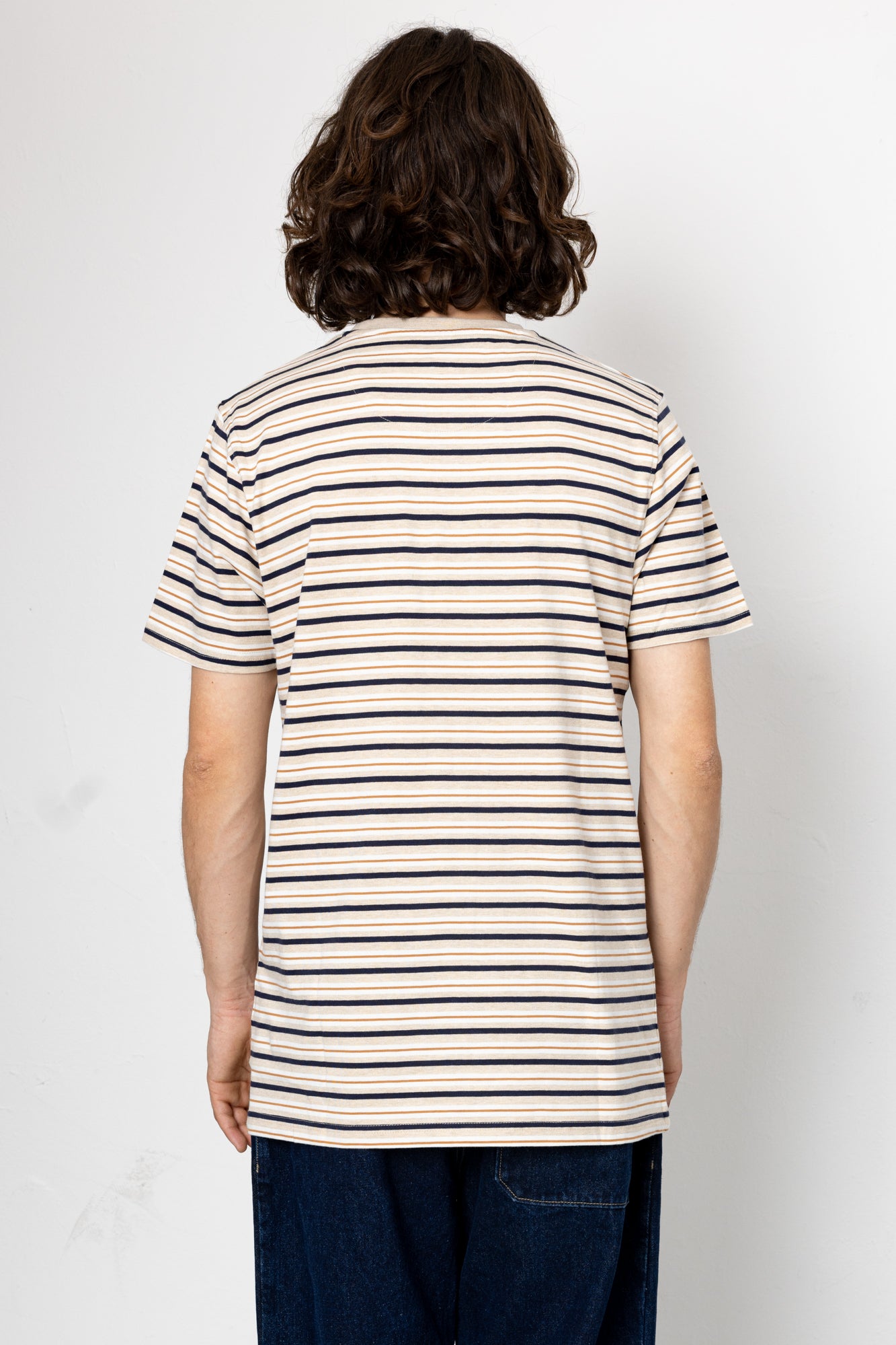 Person wearing a striped t-shirt against a plain background