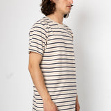 Man wearing a striped t-shirt against a plain background