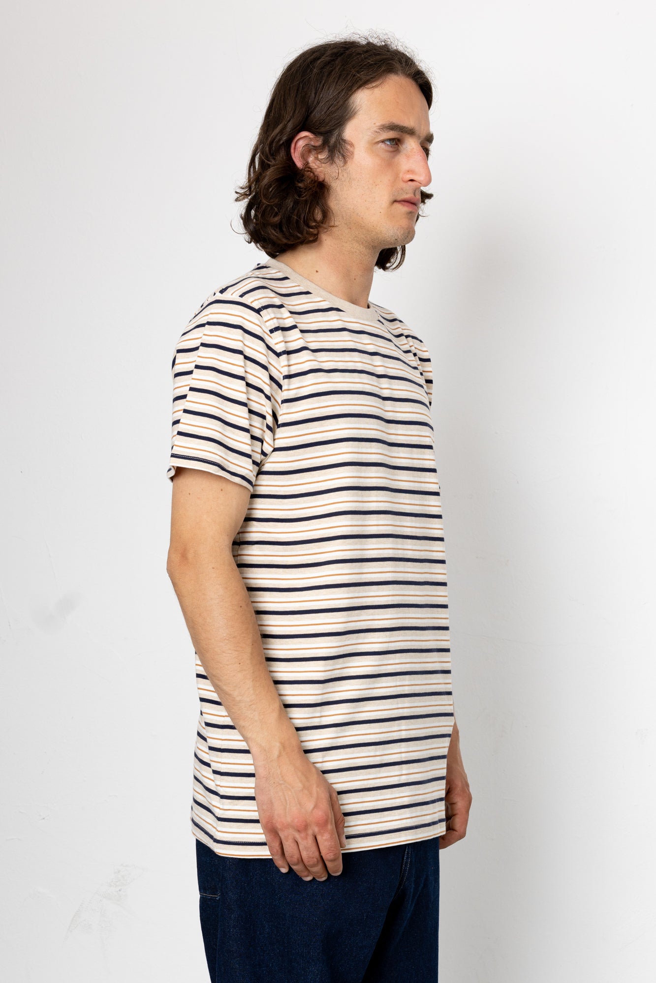 Man wearing a striped t-shirt against a plain background