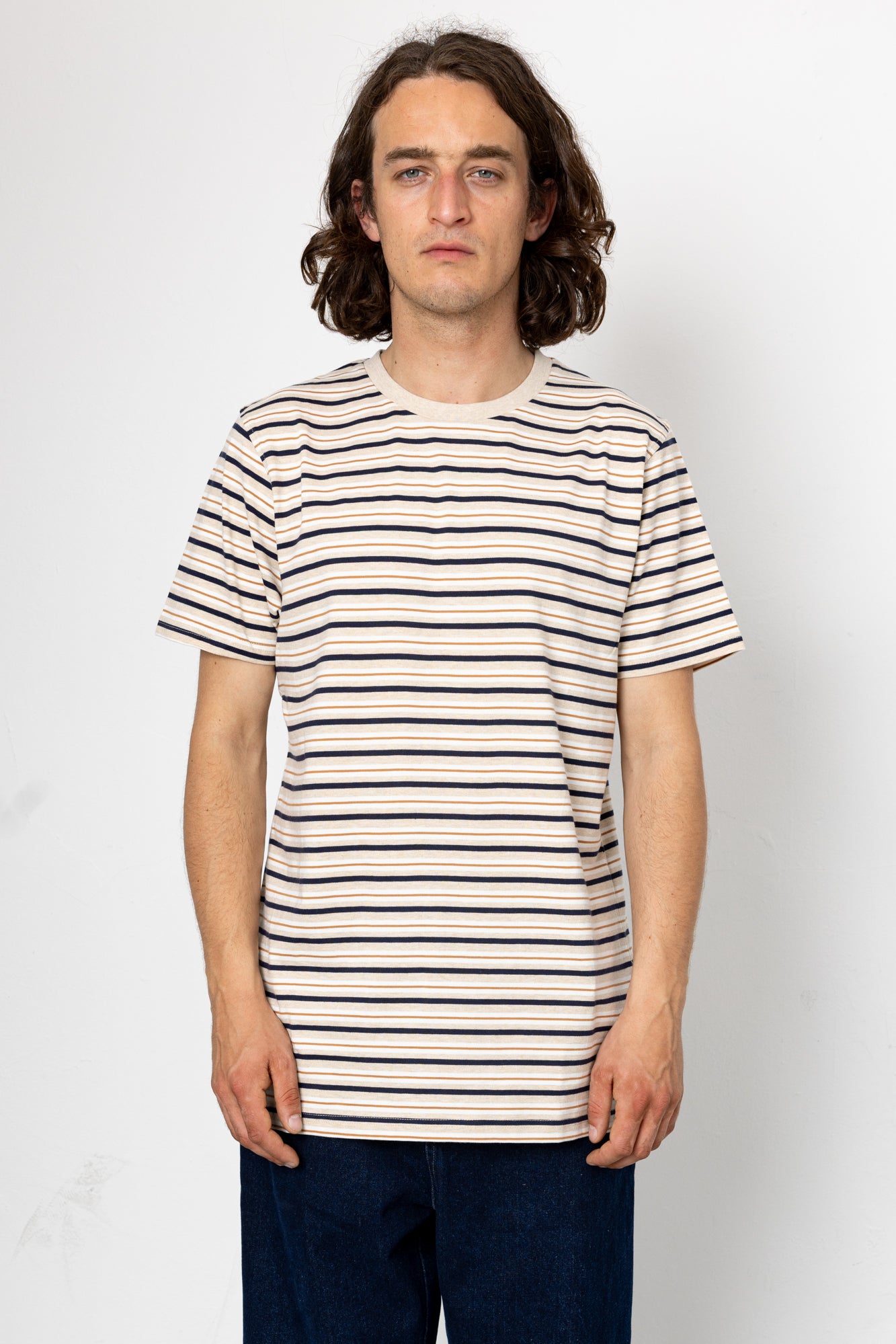 Man wearing a striped t-shirt against a white background