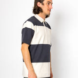 Man wearing a navy and white striped polo shirt against a white background