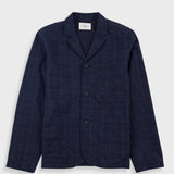 Navy blazer on a light gray background