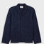 Navy blazer on a light gray background