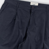 Dark blue pants with a visible brand label on a light gray background