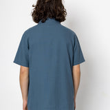 Person wearing a blue polo shirt from behind on a white background