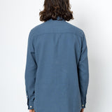 Person wearing a blue shirt with a white background