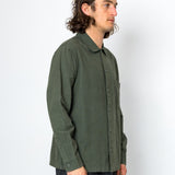 Person wearing a green shirt against a white background
