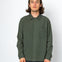 Man wearing a green button-up shirt against a white background