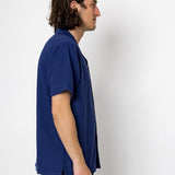 Man wearing a blue t-shirt against a white background