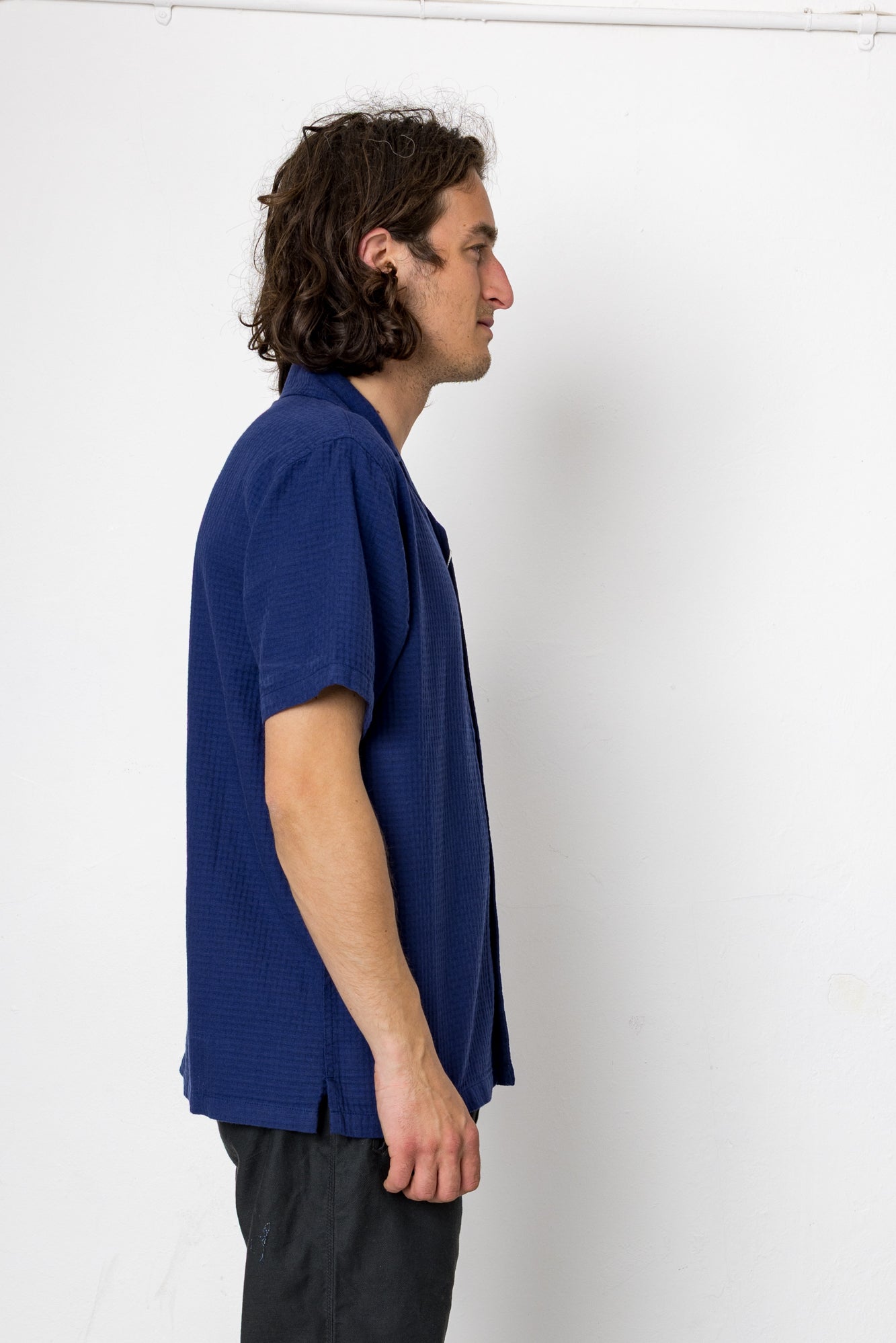 Man wearing a blue t-shirt against a white background