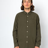Man wearing an olive green button-up shirt against a white background