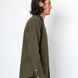 Man wearing an olive green shirt against a white background