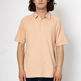 Man wearing a beige polo shirt against a white background
