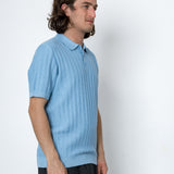 Man wearing blue polo shirt against white background
