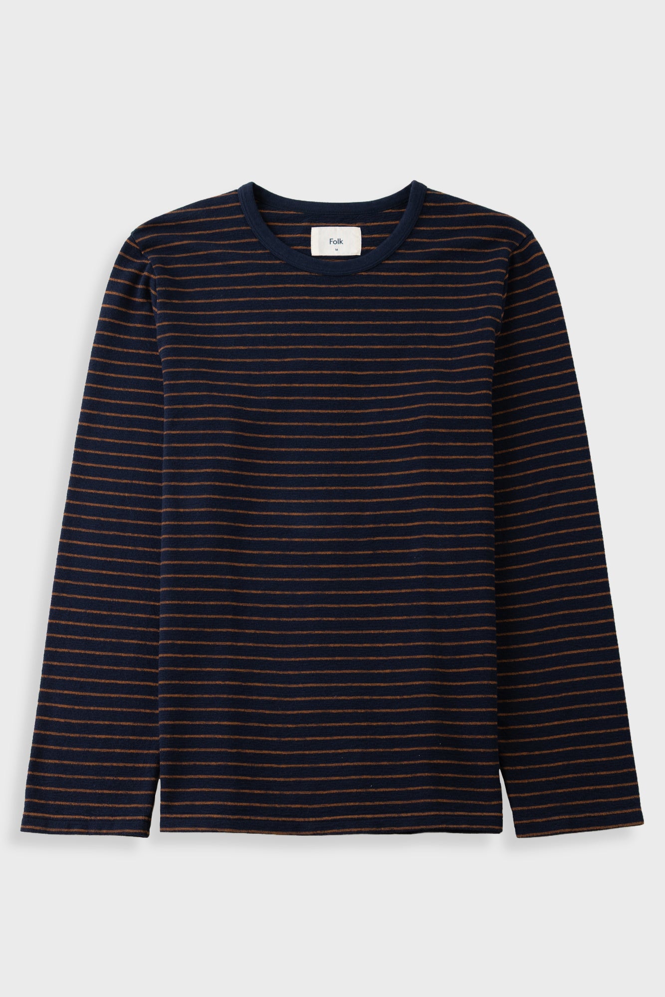 A long-sleeve crewneck knit top with thin horizontal orange stripes on a dark navy blue base, shown flat against a light gray background.