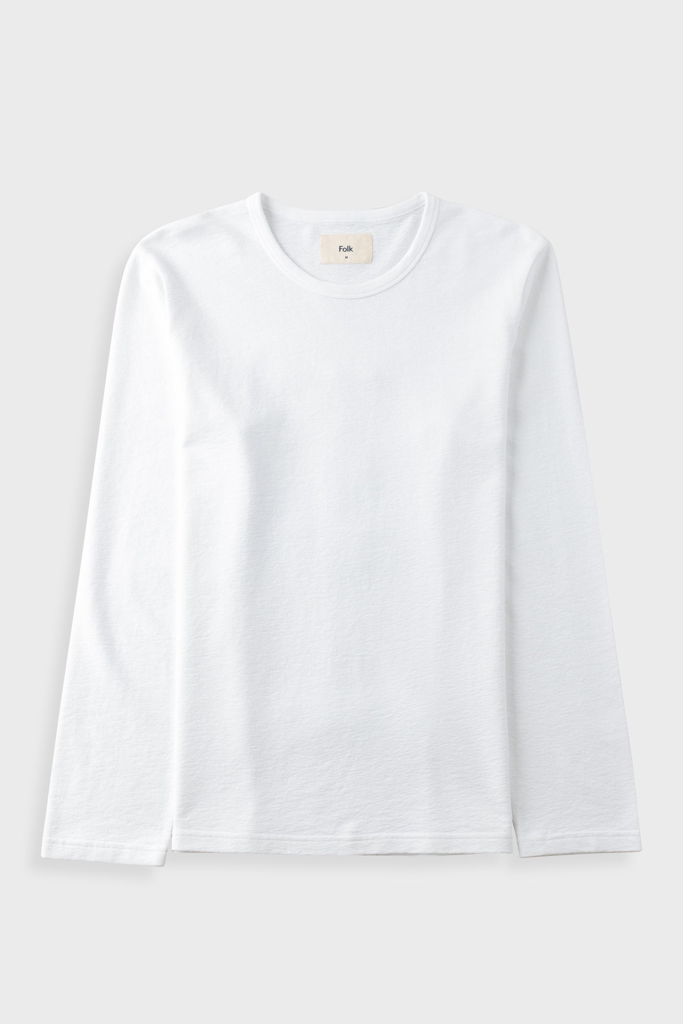 A plain white long-sleeve crewneck t-shirt laid flat against a light gray background.