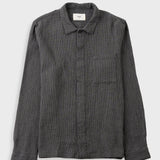A dark grey long-sleeve button-up shirt with a subtle grid pattern, featuring a classic collar and a chest pocket, laid flat against a light gray background.