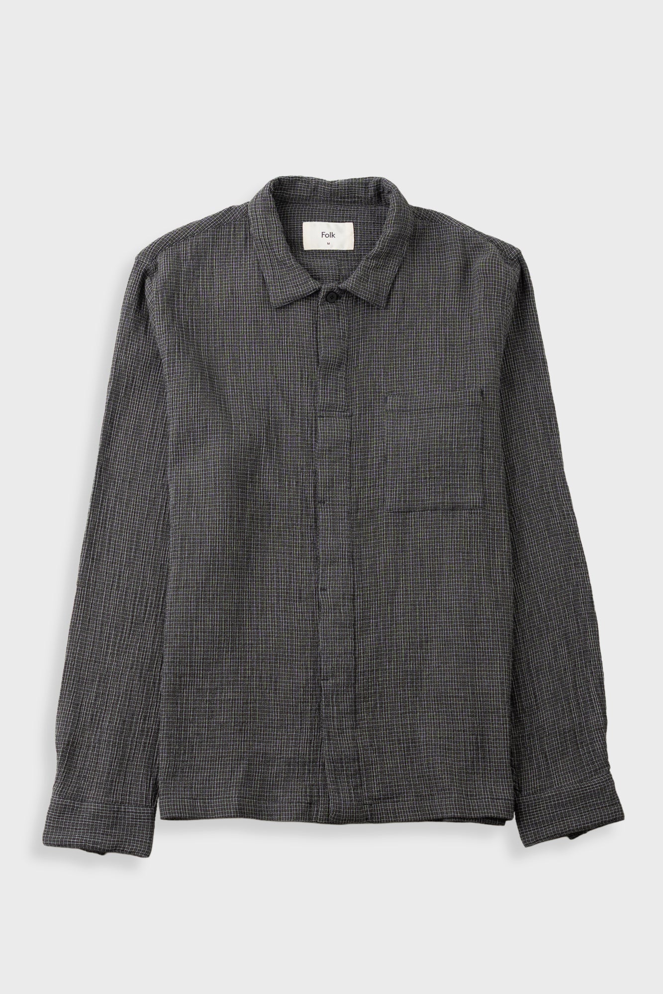 A dark grey long-sleeve button-up shirt with a subtle grid pattern, featuring a classic collar and a chest pocket, laid flat against a light gray background.