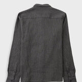 A dark gray long-sleeve button-up shirt with a subtle grid pattern, featuring a classic collar and a chest pocket, laid flat against a light gray background.
