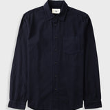 A dark navy blue long-sleeve button-up shirt with a single chest pocket, laid flat against a light gray background.