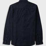 A dark navy blue long-sleeve shirt shown from the back, featuring a button-down cuff and a subtle textured weave, set against a light gray background.