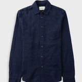 Dark navy button up shirt laid against a grey backdrop