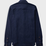 Dark navy button up shirt laid against a grey backdrop