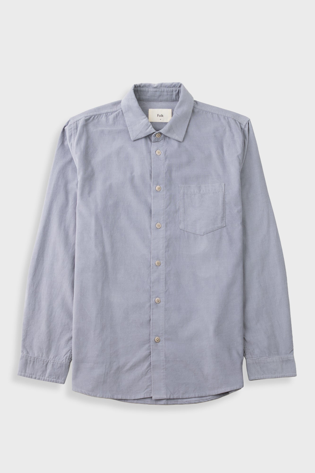 Pale fine striped blue shirt against a grey backdrop