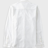 White textured shirt against a pale grey background