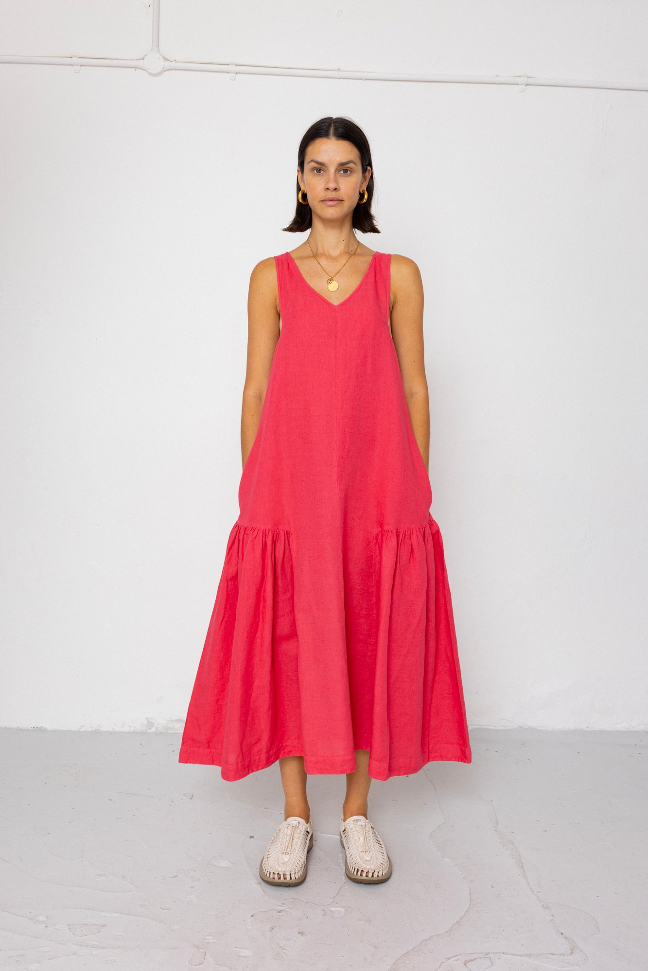 Woman wearing a red dress against a white background