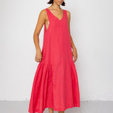 Woman wearing a red sleeveless dress against a white background