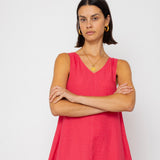 Woman wearing a pink dress against a white background
