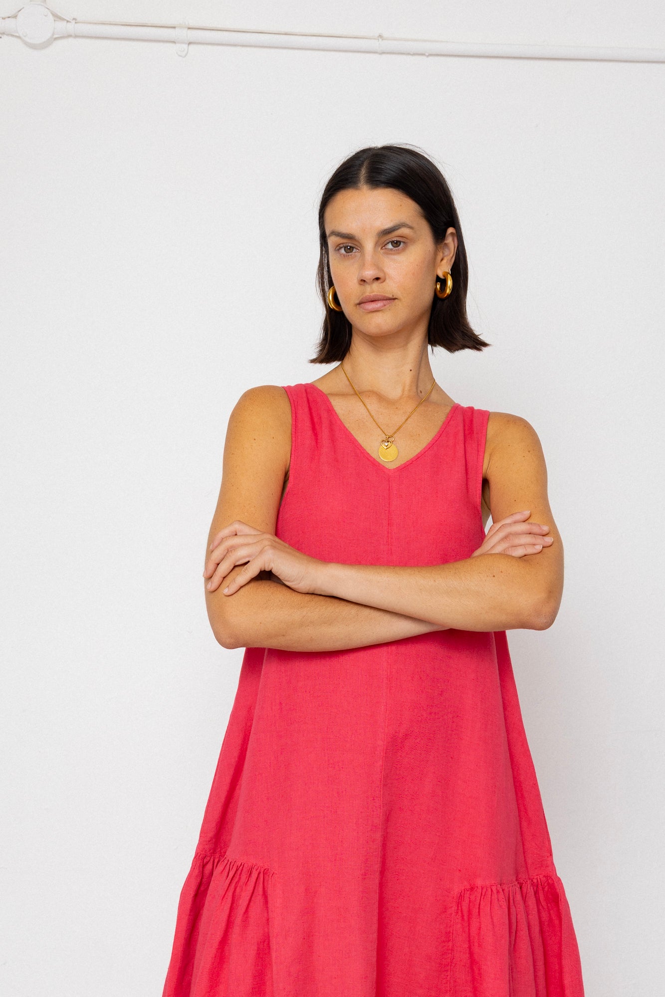 Woman wearing a pink dress against a white background