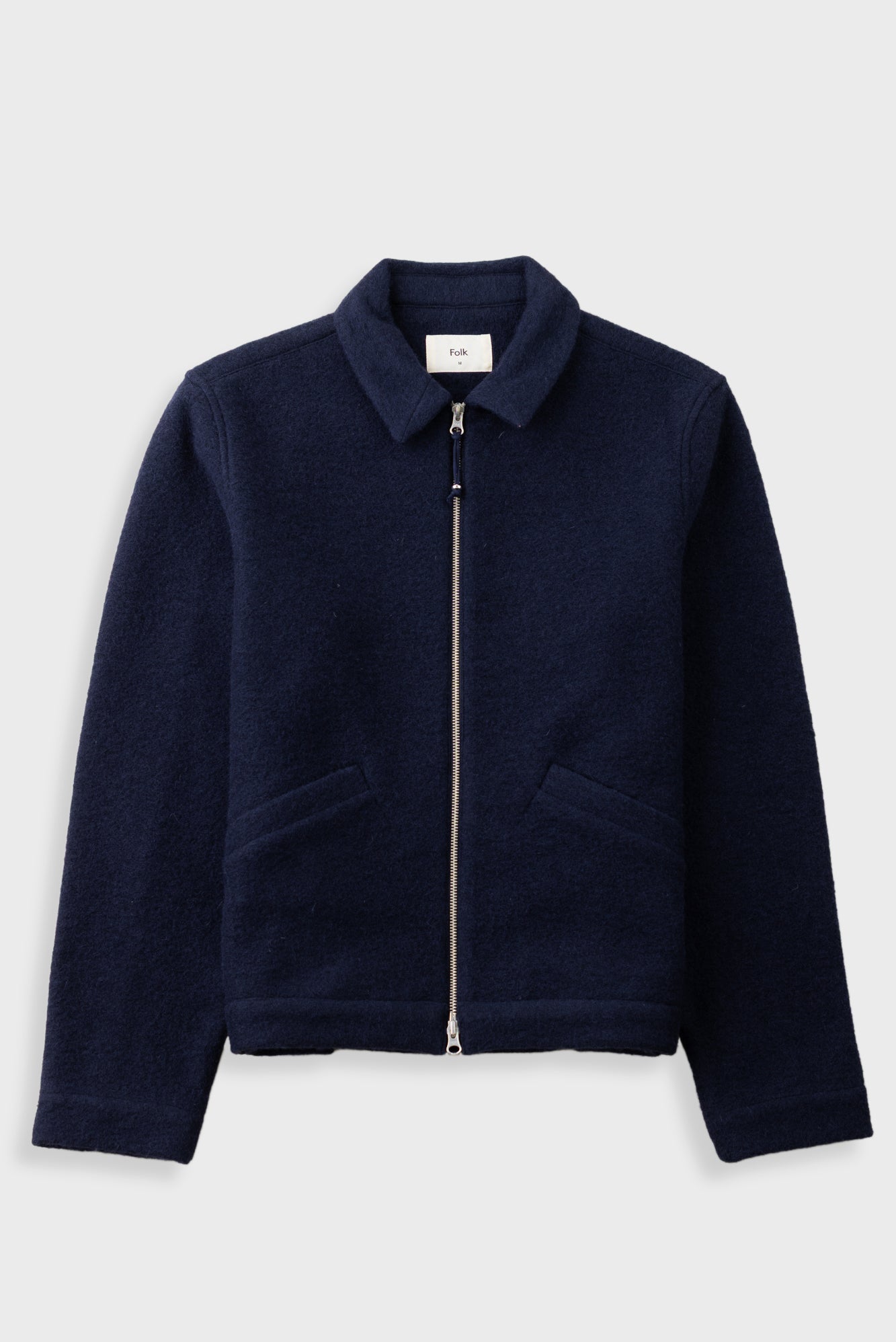 A dark navy blue fleece jacket with a zippered front, collar, and two front pockets, displayed on a light gray background.