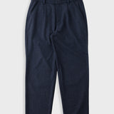 A pair of dark navy blue trousers with a textured fabric, featuring a flat front and side pockets, laid flat against a light gray background.