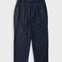 A pair of dark navy blue trousers with a textured fabric, featuring a flat front and side pockets, laid flat against a light gray background.