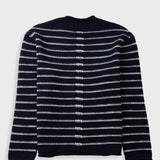 A navy blue knit cardigan sweater with horizontal white stripes, shown from the back against a light gray background.