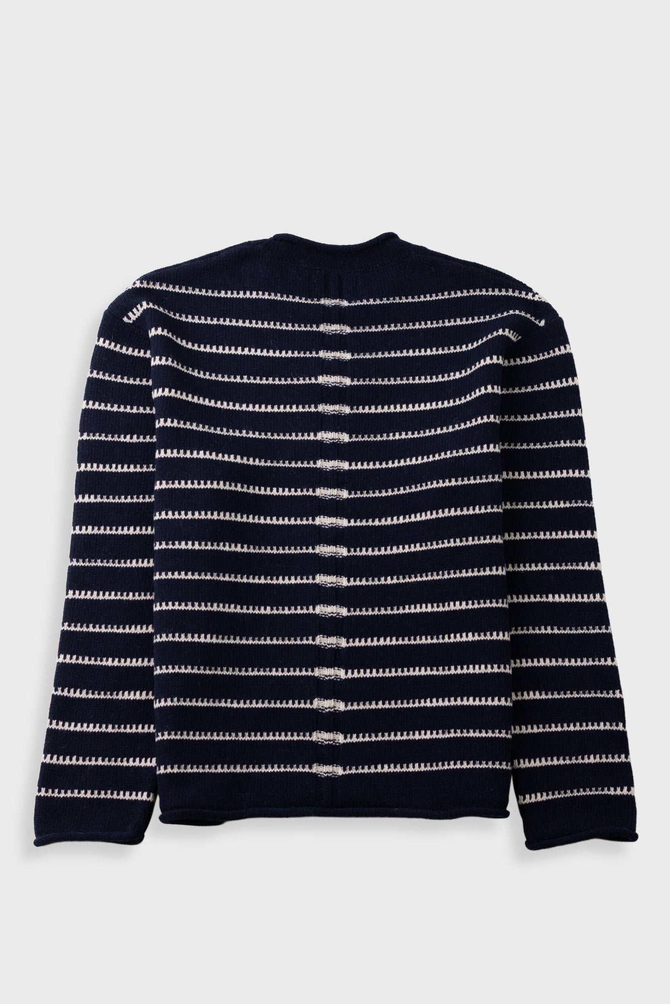 A navy blue knit cardigan sweater with horizontal white stripes, shown from the back against a light gray background.