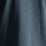 A close-up of dark heather gray fabric with soft folds and a slightly textured surface.