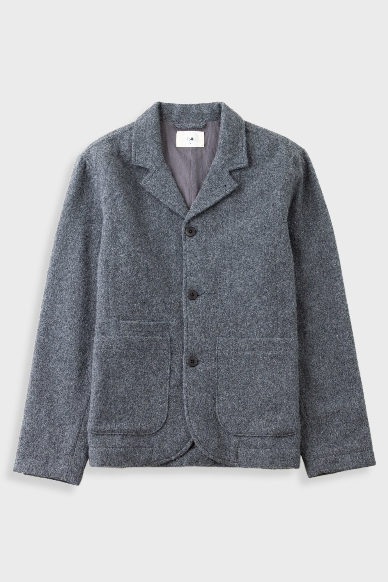 A gray textured wool-blend jacket with notch lapels, three front buttons, and two large front patch pockets, shown flat against a light gray background.