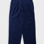 A pair of dark navy blue cropped trousers with a textured crinkle fabric, shown flat against a light gray background.