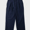 A pair of dark navy blue pinstriped trousers laid flat against a light gray background.