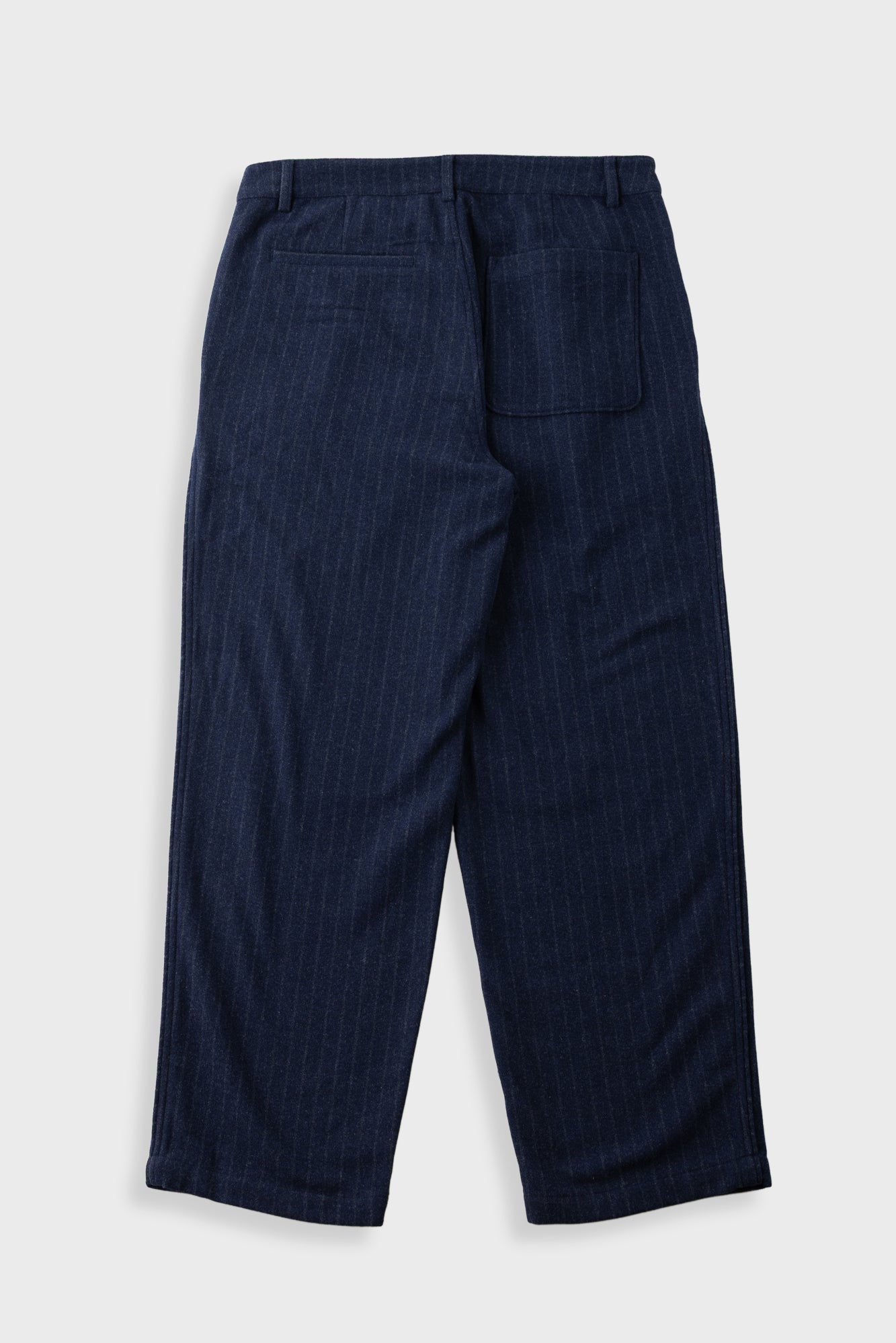 A pair of dark navy blue trousers with a subtle vertical pinstripe pattern, shown from the back on a light gray background.